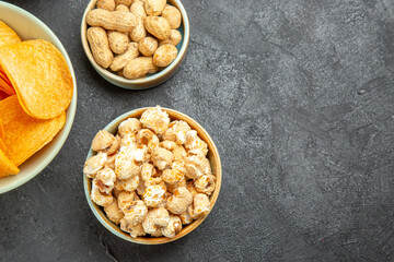 top view tasty cheese cips with different snacks on a dark background cinema photo potato nut movie junk food