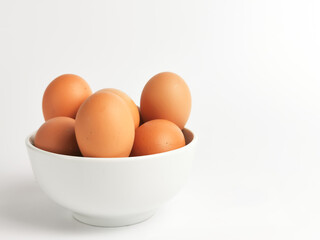Chicken eggs in a bowl isolated on white background.