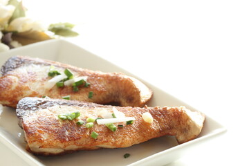 Asiian food, fried yellowtail fillet on dish with copy space