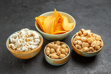 front view tasty cheese cips with different snacks on dark background nut movie cinema photo potato food