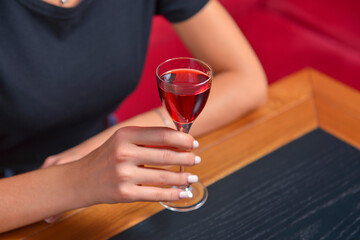Girl with cocktail, still life concept. Drinking alcohol fruit drink in a restaurant. Eating out concept.