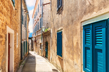 Fototapeta premium Narrow adriatic street in the Old Town of Herceg Novi, Montenegro
