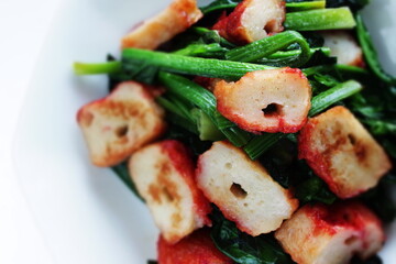 Chinese food, fish cake and green leaf vegetable Spinach stir fried
