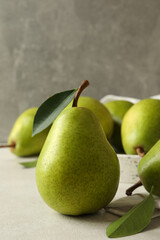 Tray with green pears on white textured background