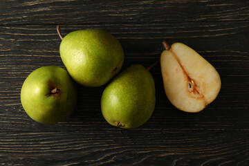 Fresh green pears on wooden background, top view