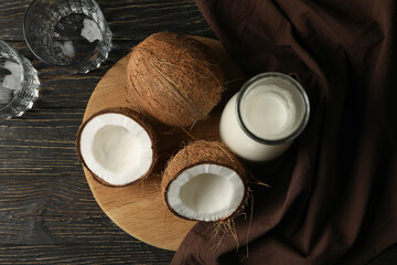 Fresh coconut and coconut milk on wooden background