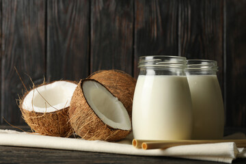 Fresh coconut and coconut milk on wooden background