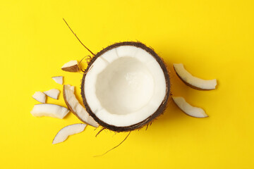 Half of fresh coconut on yellow background