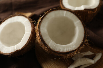 Board with coconut on brown napkin, close up