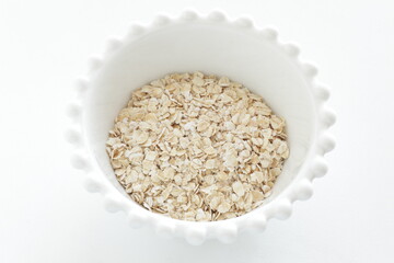 Healthy food ingredient, oatmeal in white bowl with copy space