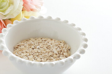Healthy food ingredient, oatmeal in white bowl with copy space