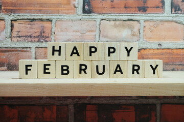 Happy February alphabet letter on shelves wooden background