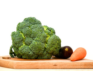 Broccoli, egglant  and carrot on cutting plate 