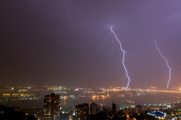 Lightning storm over night city.
