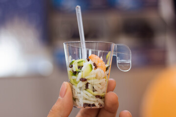 A cute italian rice salad food (insalata di riso) on a tiny free taste plastic cup in ODStore near...