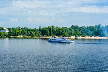 Fototapeta premium Tourist motor boat on a river Dnieper in Kiev, Ukraine