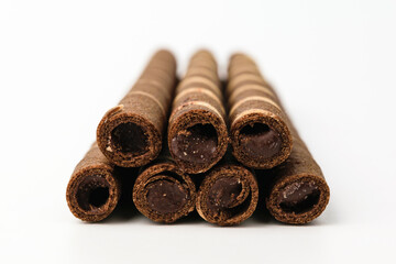 Chocolate wafer rolls on a white background