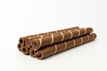 Chocolate wafer rolls on a white background