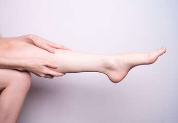 Fototapeta na wymiar massage of leg muscles with hands, leg pain