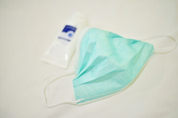 Green surgical mask on white background.
