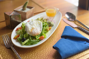 Tropical Poached eggs Salad on the table