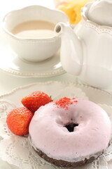 Pink strawberry chocolate coating donut served with strawberry