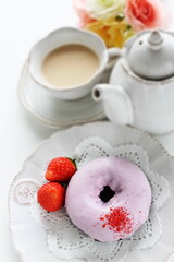 Pink strawberry chocolate coating donut served with strawberry