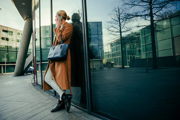 Caucasian business woman chatting on cellular device enjoying lunch break