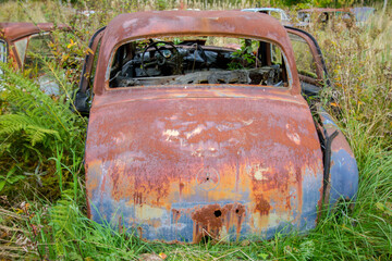 rusty old vintage cars, some with missing doors and windows, Bastnäs, Car Cemetry, damaged cars in...