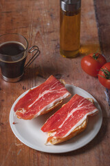 Traditional Spanish appetizer, tomato bread with Spanish ham.