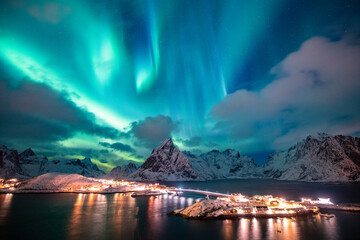 Aurora borealis on the Hamnoy village in Lofoten islands, Norway. Green northern lights above...