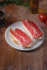 Traditional Spanish appetizer, tomato bread with Spanish ham.