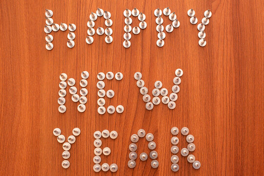 Christmas layout for a carpenter. On a wooden surface, the text Happy New Year is lined with screws