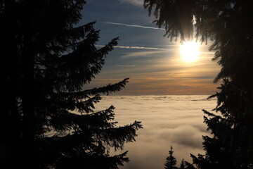 
sunset above the clouds in the mountains