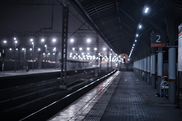 Fototapeta premium railway tracks night landscape at the railway station fog autumn