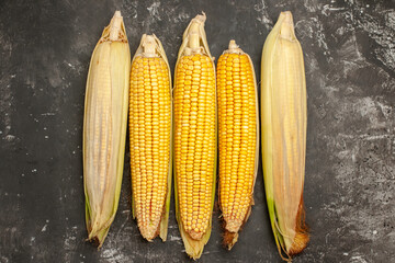 top view fresh yellow corns on dark background raw color photo plant food