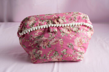 Closeup of a pink floral fabric purse