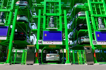 Many cars are parked in automatic multi level open space car parking lot