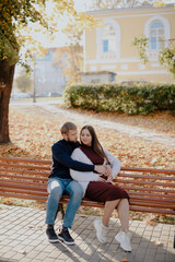 Fototapeta na wymiar Young adult couple in love in autumn Park