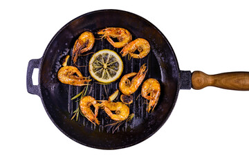 Roasted shrimps with lemon slice, garlic and rosemary in a cast iron pan isolated on white...