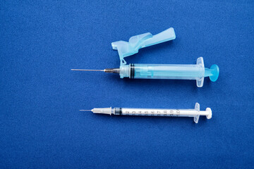 Set of syringes on blue background with copy space