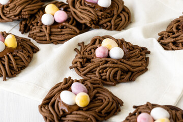 Easter chocolate cookies. Nests with sweet eggs on white background