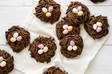 Fototapeta na wymiar Easter chocolate cookies. Nests with sweet eggs on white background