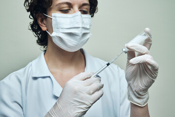 View of a Nurse preparing vaccine dose