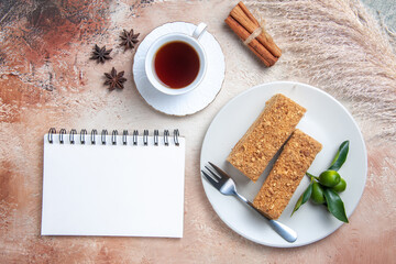 top view cake slices honey cake with cup of tea on light background sweet biscuit cake pie