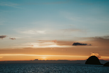 Fototapeta na wymiar Sunset view with ocean and Mantou rock at Lanyu island. The combination of blue and orange sky.