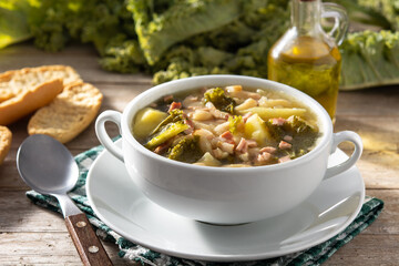 Creamy Tuscan soup in bowl on wooden table	