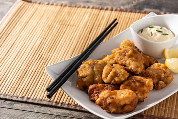Spicy chicken karaage on wooden table.Copy space
