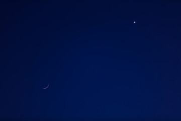 Astronomical conjunction of Venus and Moon, photographed with long focal lens.