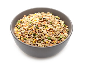 Mixed legumes and cereals, peeled barley, green, yellow and dark red lentils, half green peas, black white beans, green beans in porcelain bowl isolated on white background
